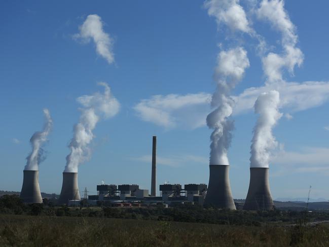 05/05/2023. Gerard Spinks, 59, Bayswater plant assistant manager, has worked in coal fired plants for more than four decades and is concerned about what will happen to workers as the economy detransitions. Photographed with  Bayswater Power station in the background, 15 minutes south of Muswellbrook in NSW. Britta Campion / The Australian