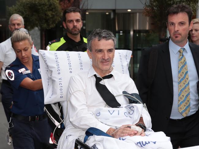 Dover responsible manager and owner Terry McMaster leaves the Federal Court with the aid of paramedics after collapsing while being questioned during the Banking Royal Commission in Melbourne, Thursday, April 26, 2018. The head of a financial advice firm has collapsed in the stand at the banking royal commission after begin accused of lying. (AAP Image/Stefan Postles) NO ARCHIVING