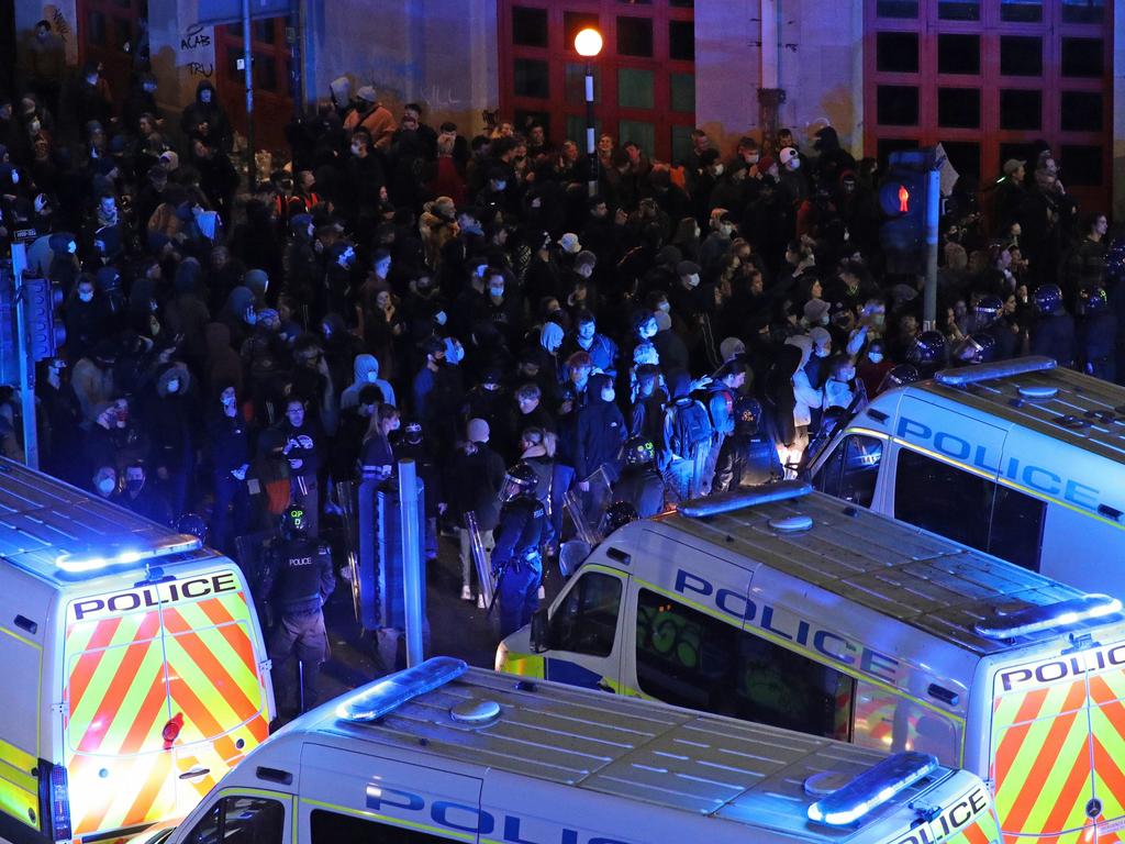 Riot police, with police horses and police vehicles, move down Rupert Street in Bristol. Picture: Andrew Matthews/PA Wire /AAP