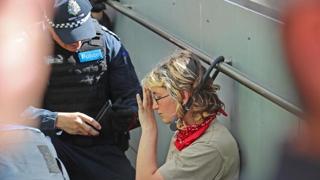 A woman is arrested after locking herself to a hand rail on a disabled ramp. Picture: Alex Coppel.