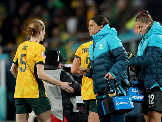 Cortnee Vine (L) greets Sam Kerr as the injured star prepares to deliver water bottles onto the pitch for her teammates during the FIFA Women's World Cup match between Australia and Ireland. Picture: Getty Images