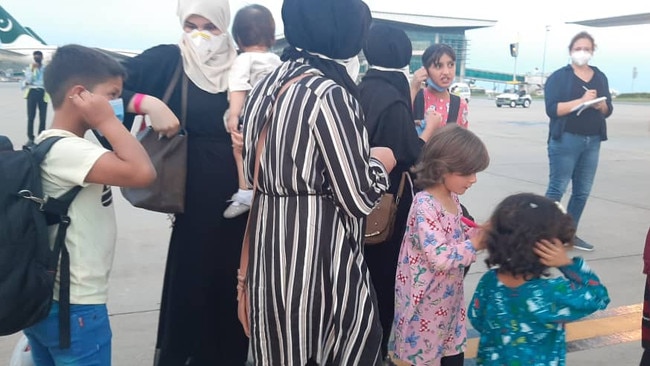 The group gets ready to board the plane in Pakistan, bound for Australia.