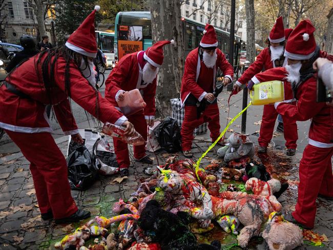 Extinction Rebellion activists throw paint on stuffed toys during an action to denounce the government's environmental policy on the eve of the start in Montreal of the COP15 biodiversity summit in Paris, on December 6.