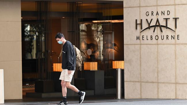 A man walks past the Grand Hyatt hotel in Melbourne where preparations for the Australian Open were thrown into chaos when up to 600 players and officials were told to isolate and get tested after a Grand Hyatt hotel staff member tested positive. Picture: William West/AFP