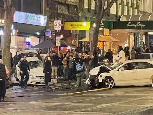 A man believed to be the driver sits on the roof after the crash. Picture: Supplied