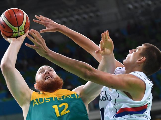 Serbian power forward Nikola Jokic (R) defends against Australian forward Aron Baynes.