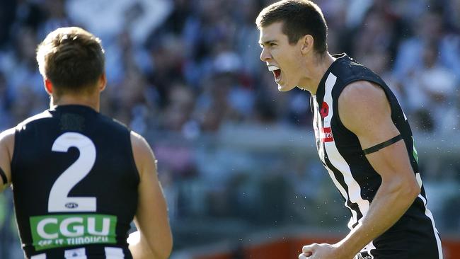 Mason Cox kicks the first goal on Anzac Day. Picture: George Salpigtidis