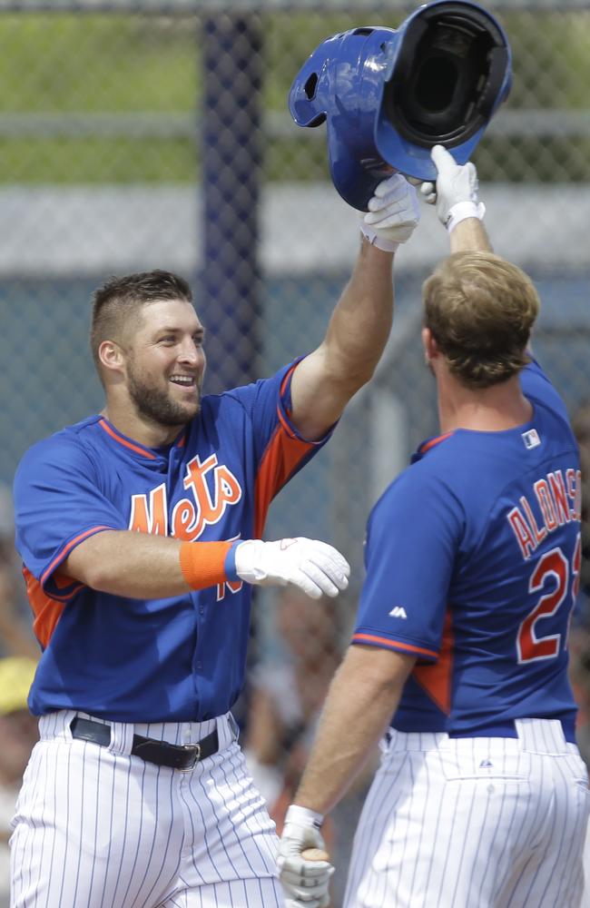 Tim Tebow is greeted by Peter Alonso after hitting a solo home run.