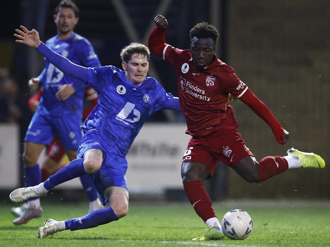 Adelaide United’s Nestory Irankunda under pressure from Tremayne Sadler of Northcote City. Picture: Daniel Pockett