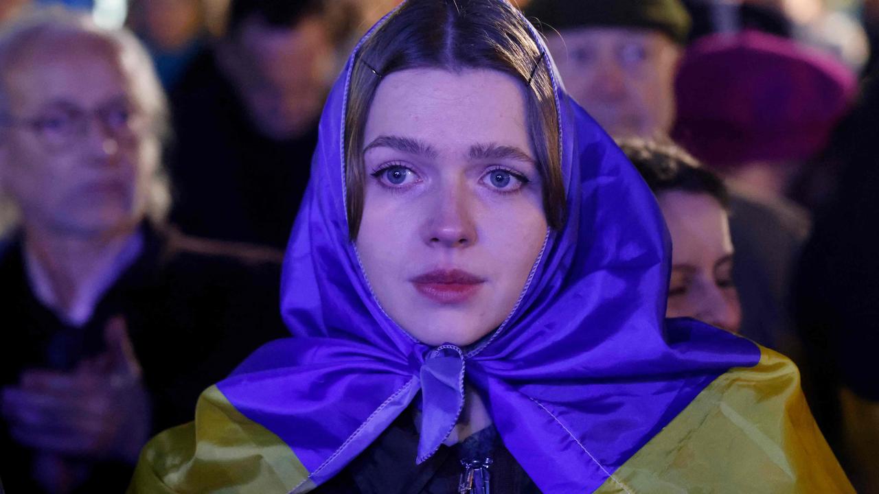 A woman looks on as she attends a gathering in support of Ukraine on the Place de la Republique in Paris. Picture: Ludovic Marin/AFP