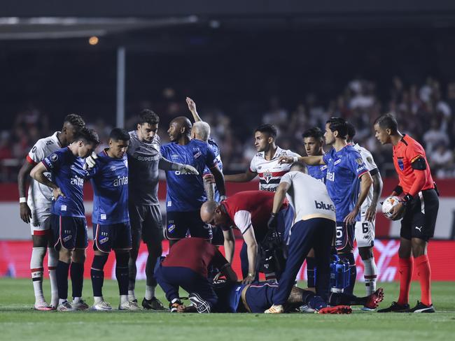 Izquierdo receiving medical attention. (Photo by Alexandre Schneider/Getty Images)