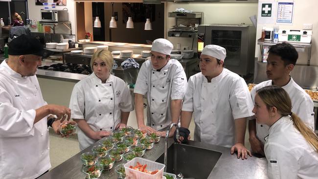 Golinski sharing his expertise with the young chefs in the Beenleigh State High School kitchen.