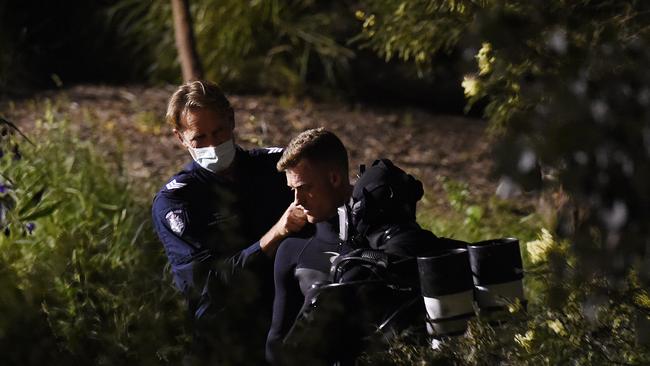 Police divers prepare to enter the water. Picture: Josie Hayden