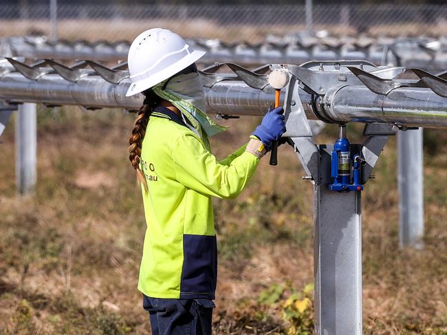 A worker checks newly constructed metal frames for photovoltaic modules at a solar farm on the outskirts of Gunnedah, New South Wales, Australia, on Friday, April 16, 2021. Most Australians would prefer investment inÃÂ clean energyÃÂ to help lift the economy out of its Covid-induced recession to the governments plan for a "gas-fired" recovery. Photographer: David Gray/Bloomberg via Getty Images