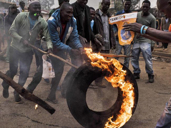 Men move a burning tire during a protest in Kibera, Kenya’s biggest slum, on August 9, 2017 in Nairobi, Kenya. The protest started after police allegedly killed two protestors in Mathare, another slum in Nairobi. Tensions remain high as rumors of election fraud surround the presidential election between incumbent president Uhuru Kenyatta and his rival Raila Odinga. PICTURE: Andrew Renneisen/Getty Images