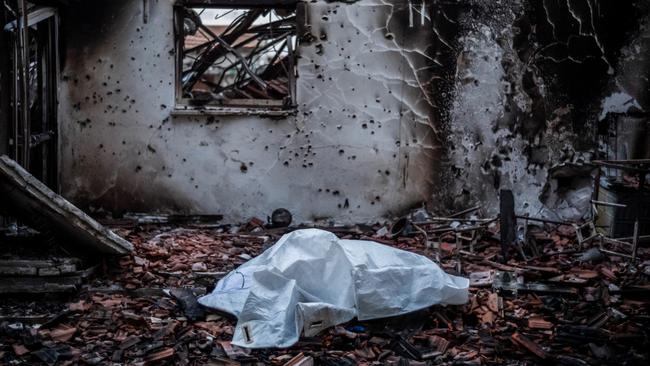 A body lies in the burnt-out remains of a home in Kibbutz Be’eri on October 11 last year, four days after Hamas butchers raped, tortured and murdered 1200 innocent people in southern Israel. Picture: Getty Images