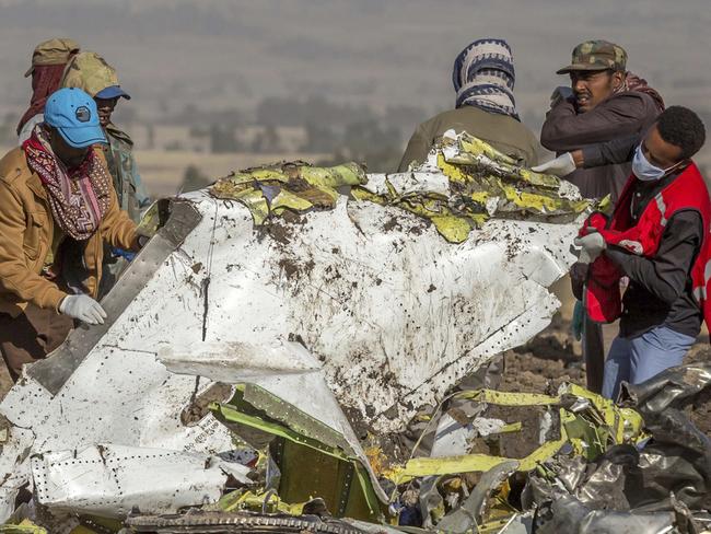 FILE - In this March 11, 2019, file photo, rescuers work at the scene of an Ethiopian Airlines flight crash near Bishoftu, Ethiopia. A published report says pilots of an Ethiopian airliner that crashed followed Boeingâ€™s emergency steps for dealing with a sudden nose-down turn but couldnâ€™t regain control. (AP Photo/Mulugeta Ayene, File)