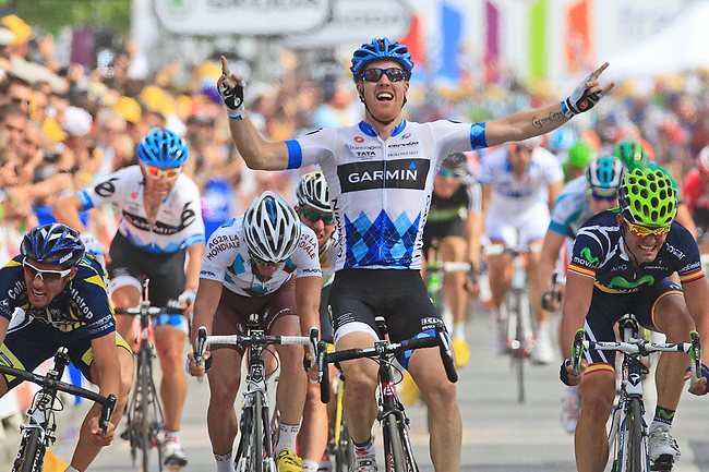 <p>Tyler Farrar celebrates as he crosses the finish line ahead of Romain Feillu of France, left, and Jose Joaquin Rojas of Spain to win the third stage of the Tour de France.</p>