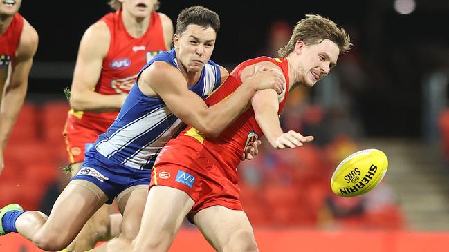 Gold Coast’s Noah Anderson is tackled. Picture: Chris Hyde/Getty Images