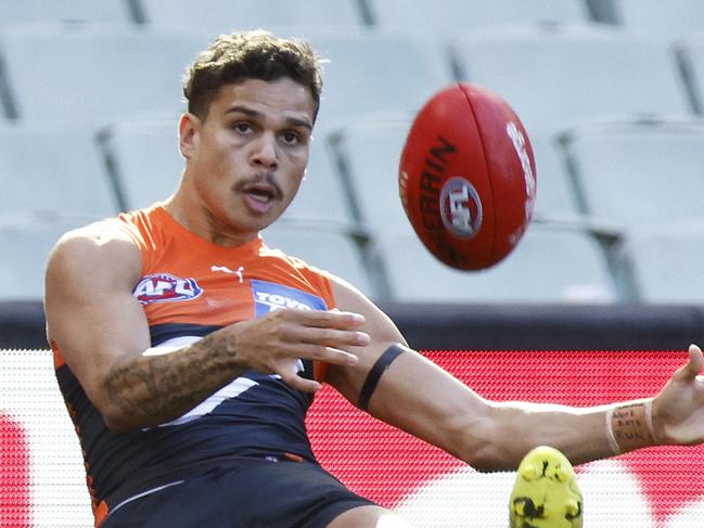 MELBOURNE, AUSTRALIA - JUNE 27: Bobby Hill of the Giants kicks for goal during the round 15 AFL match between the Greater Western Sydney Giants and the Hawthorn Hawks at Melbourne Cricket Ground on June 27, 2021 in Melbourne, Australia. (Photo by Daniel Pockett/Getty Images)