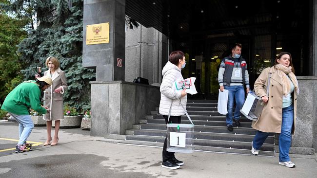 Election commission members with mobile ballot boxes leave the embassy of the self-proclaimed Donetsk People's Republic. Picture: AFP