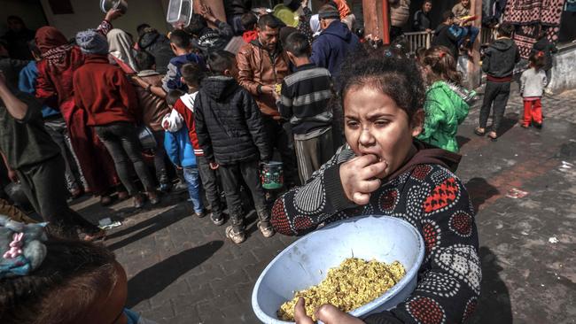 Displaced Palestinian children gather to receive food amid the ongoing battles between Israel and the militant group Hamas. Picture: AFP