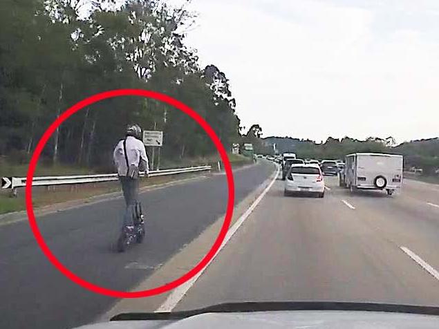 A man seen riding an escooter on the M1 in Helensvale on Friday December 1, 2023. Picture: Mark Boothman MP.