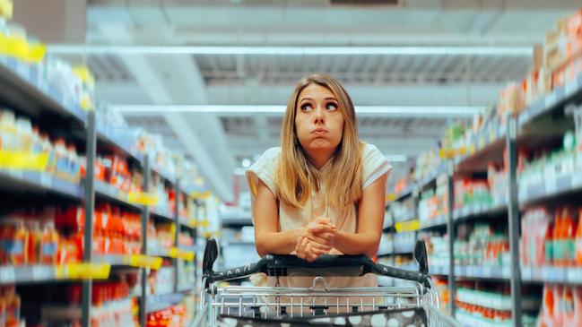 Buyer deciding about purchases in a big store. istock image