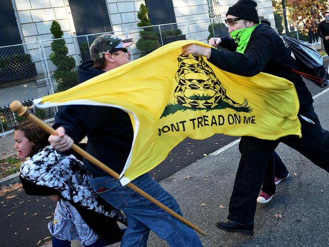 Counter-protesters clash with a supporter (C) of US President Donald Trump at Black Lives Matter Plaza during a rally in Washington, DC. Picture: AFP