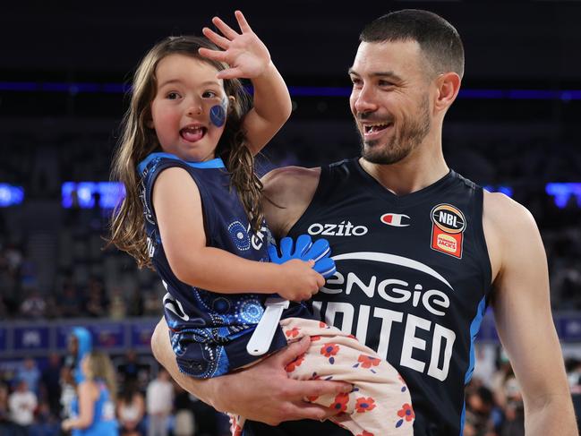 MELBOURNE, AUSTRALIA - OCTOBER 13: Chris Goulding of United celebrates with hs daughter after playing his 450th game and winning the round four NBL match between Melbourne United and Adelaide 36ers at John Cain Arena, on October 13, 2024, in Melbourne, Australia. (Photo by Daniel Pockett/Getty Images)