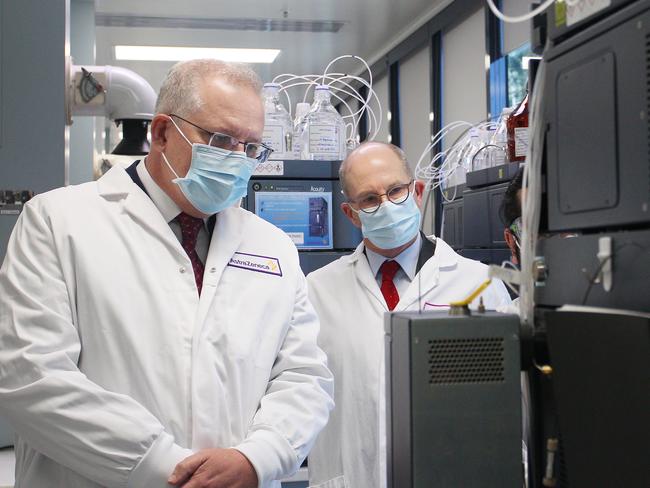 SYDNEY, AUSTRALIA - AUGUST 19: Prime Minister Scott Morrison and Professor Peter Kelly meet with team members of the Analytical Laboratory at AstraZeneca on August 19, 2020 in Sydney, Australia. The Australian government has announced an agreement with the British pharmaceutical giant AstraZeneca to secure at least 25 million doses of a COVID-19 vaccine if it passes clinical trials.  The University of Oxford COVID-19 vaccine is currently in phase-three testing. If the vaccine proves to be successful, Australia will manufacture and supply vaccines and will be made available for free. The project could deliver the first vaccines by the end of this year or by early 2021. (Photo by Lisa Maree Williams - Pool/Getty Images)