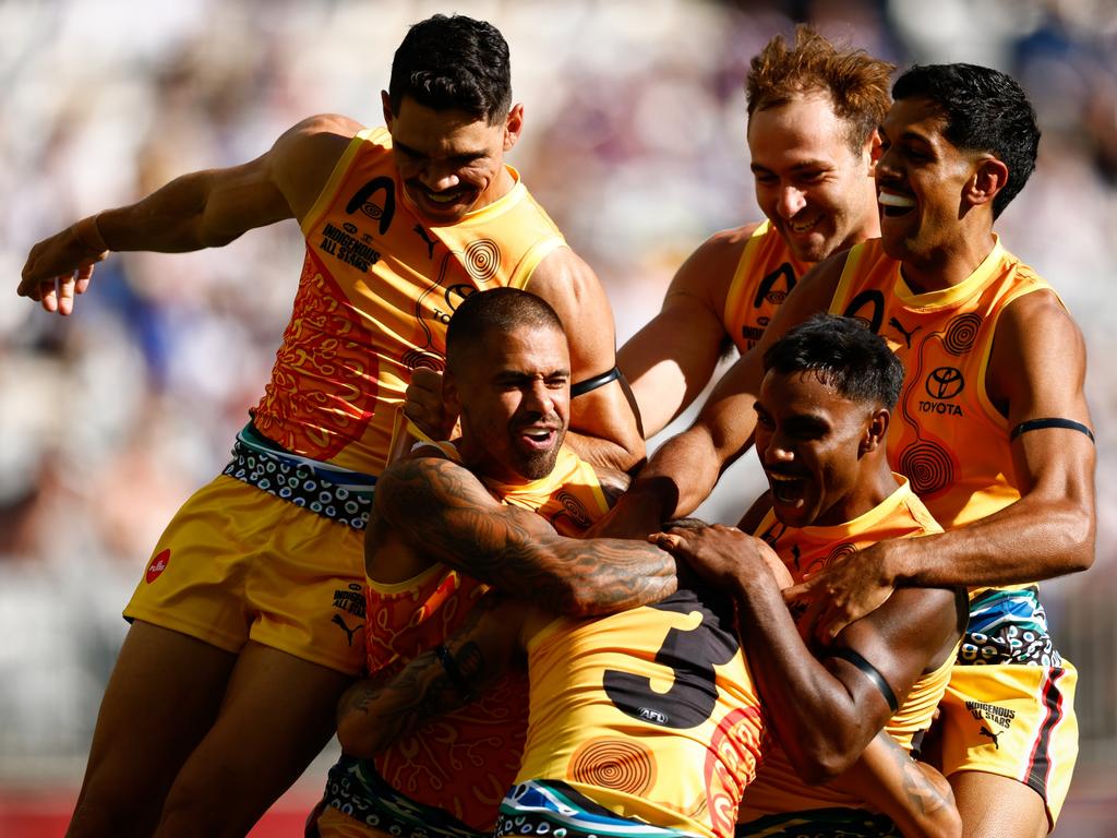 PERTH, AUSTRALIA - FEBRUARY 15: Bobby Hill of the Indigenous All Stars celebrates a goal with teammates during the 2025 Toyota AFL Indigenous All Stars match between the Indigenous All Stars and the Fremantle Dockers at Optus Stadium on February 15, 2025 in Perth, Australia. (Photo by Dylan Burns/AFL Photos via Getty Images)