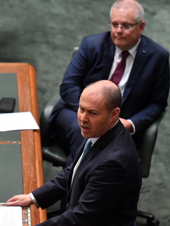 Prime Minister Scott Morrison listens as Treasurer Josh Frydenberg delivers the statement. Picture: AAP