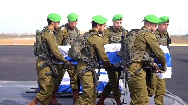 Israeli soldiers carry the coffins of deceased hostages Oded Lifschitz, Kfir and Ariel Bibas and what was purportedly Shiri Bibas. Picture: Government Press Office / GPO