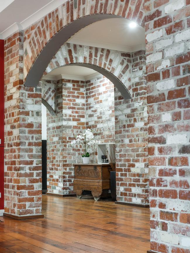 Exposed brick walls give the home a distinctly industrial vibe.