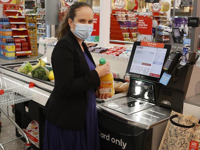 DAILY TELEGRAPH. NOVEMBER 23, 2021.Pictured at Coles at Westfield in Bondi Junction is Journalist Emily Macdonald trying out their new self serve conveyor belt registers. Picture: Tim Hunter.