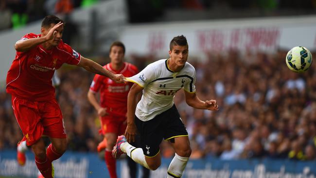 Dejan Lovren of Liverpool pulls on the shirt of Erik Lamela of Spurs.