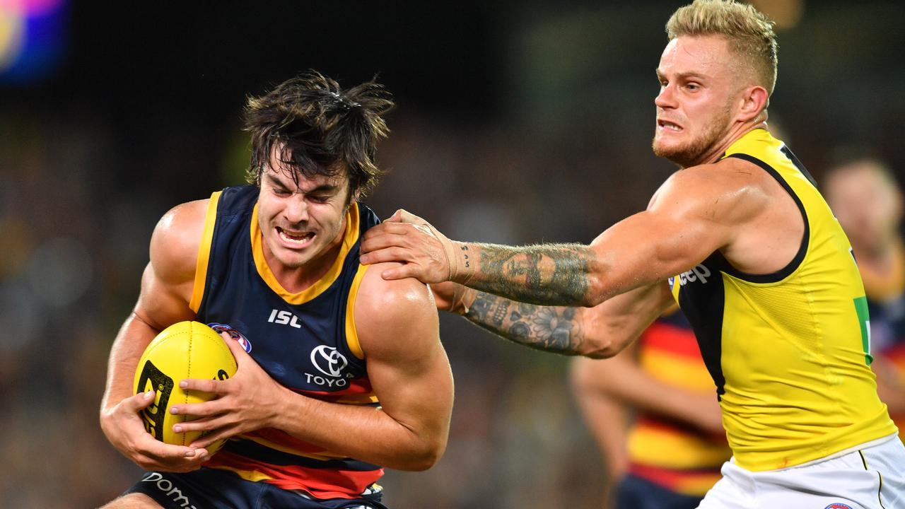 Darcy Fogarty of the Crows is tackled by Brandon Ellis of the Tigers during the Round 2 AFL match between the Adelaide Crows and the Richmond Tigers at Adelaide Oval in Adelaide, Thursday, March 29, 2018. (AAP Image/David Mariuz) NO ARCHIVING, EDITORIAL USE ONLY