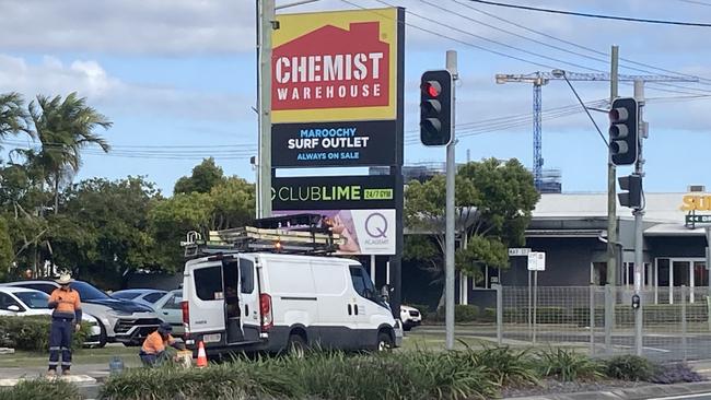 Workers at the corner of Aerodrome Rd and May St in Maroochydore following a crash in which a ute hit the traffic lights and then the driver fled.