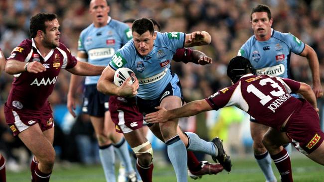 Ben Cross tries to break trough the Queensland defence in 2008.