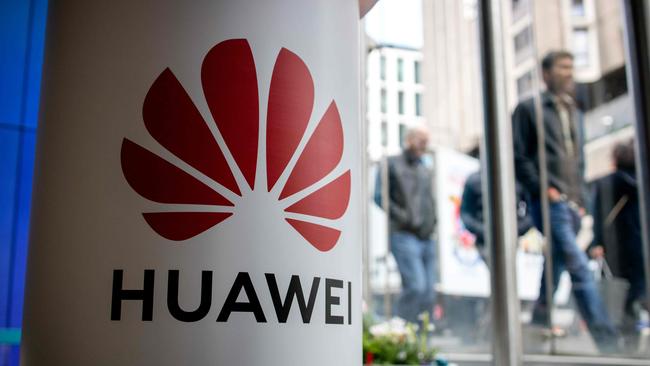 A pedestrian walks past a Huawei product stand at an EE telecommunications shop in central London. Picture: AFP