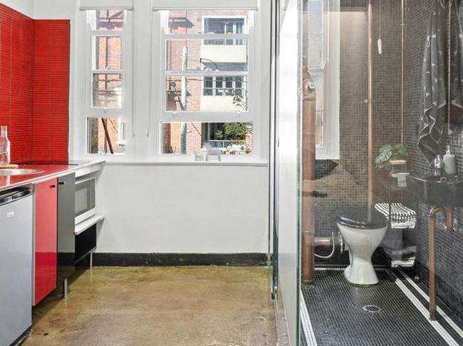 Only semi-frosted glass separates the toilet from the stove.