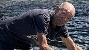 Mr Glover on board his dingy at Jacobs Well which he used to get to shore. Picture: Supplied