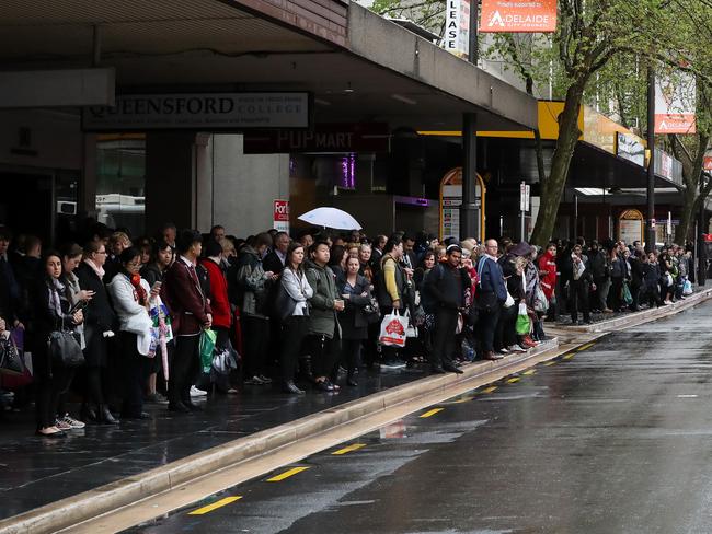 Commuters line up for buses on King William Street. Picture: Calum Robertson