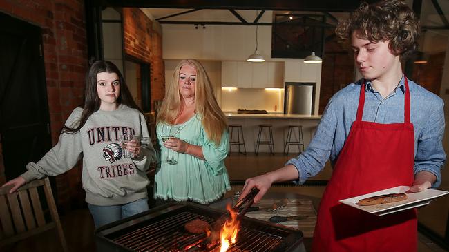 Emily Perkins, with daughter Manon and son Hugo, fire up the barbecue at home in Highett. Picture: Ian Currie