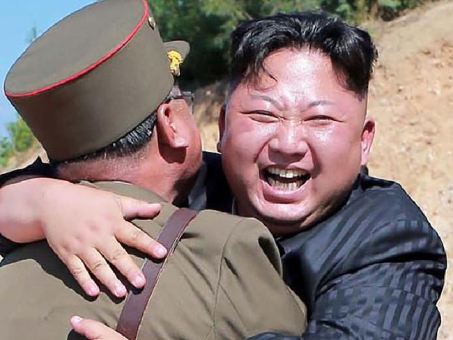 TOPSHOT - This picture taken on July 4, 2017 and released by North Korea's official Korean Central News Agency (KCNA) on July 5, 2017 shows North Korean leader Kim Jong-Un (C) celebrating the successful test-fire of the intercontinental ballistic missile Hwasong-14 at an undisclosed location. South Korea and the United States fired off missiles on July 5 simulating a precision strike against North Korea's leadership, in response to a landmark ICBM test described by Kim Jong-Un as a gift to "American bastards". / AFP PHOTO / KCNA VIA KNS / STR / South Korea OUT / REPUBLIC OF KOREA OUT   ---EDITORS NOTE--- RESTRICTED TO EDITORIAL USE - MANDATORY CREDIT "AFP PHOTO/KCNA VIA KNS" - NO MARKETING NO ADVERTISING CAMPAIGNS - DISTRIBUTED AS A SERVICE TO CLIENTS THIS PICTURE WAS MADE AVAILABLE BY A THIRD PARTY. AFP CAN NOT INDEPENDENTLY VERIFY THE AUTHENTICITY, LOCATION, DATE AND CONTENT OF THIS IMAGE. THIS PHOTO IS DISTRIBUTED EXACTLY AS RECEIVED BY AFP.    /