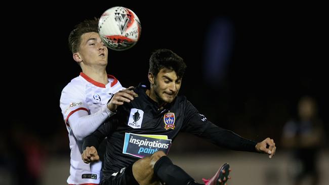 Will Bower of Edgeworth FC (back) and John Koutroumbis of the Newcastle Jets compete for the ball. Picture: Getty Images