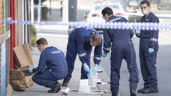 Forensic police examine items at the scene of a multiple shooting outside Love Machine nightclub in Prahran. Picture: Ellen Smith