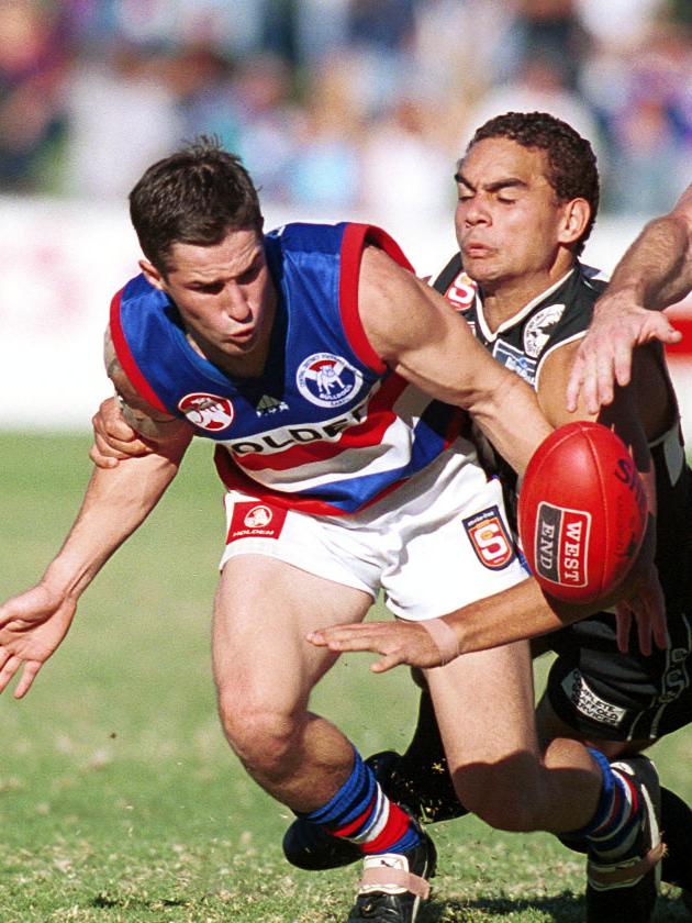 Shaun Burgoyne tackles Central District player Matt Slade in 2001.