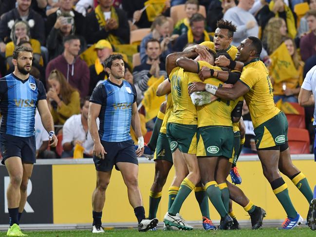 Reece Hodge celebrates scoring a try with teammates during the match between Australia and Argentina in Brisbane last month.